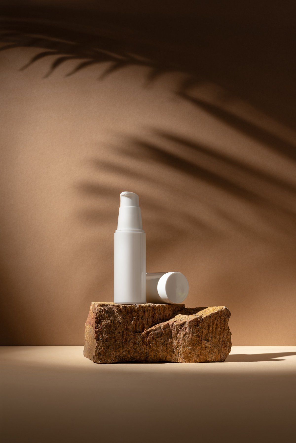 Premium cosmetic product on natural stone with warm, soft lighting