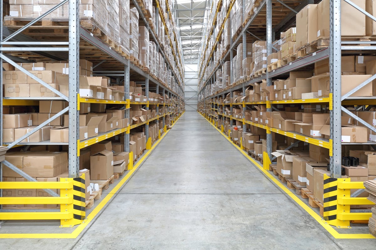 Long aisle of neatly organized shelves in a clean fulfillment warehouse